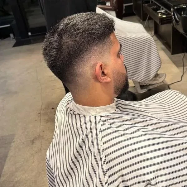 Precision haircut being finished at a client's home