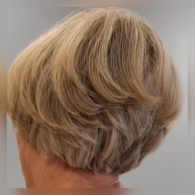Soft layered blonde blow-dry, styled at a client's home